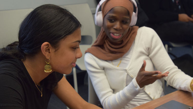Students collaborating at a laptop