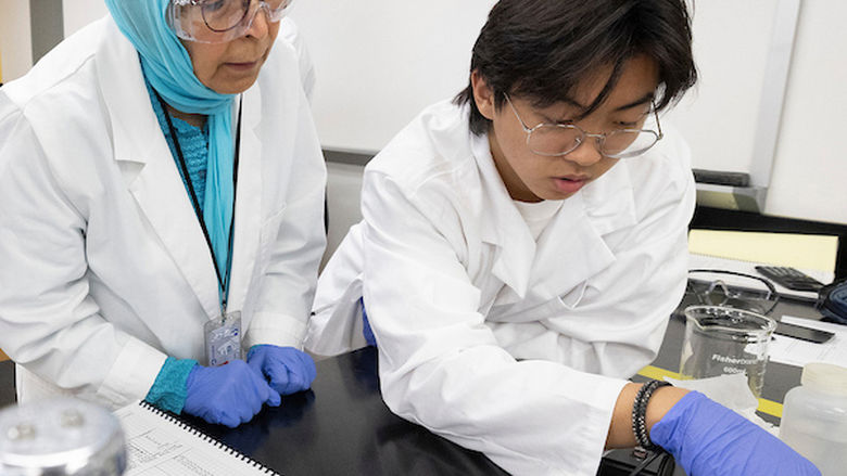 professor and student talking in physics lab