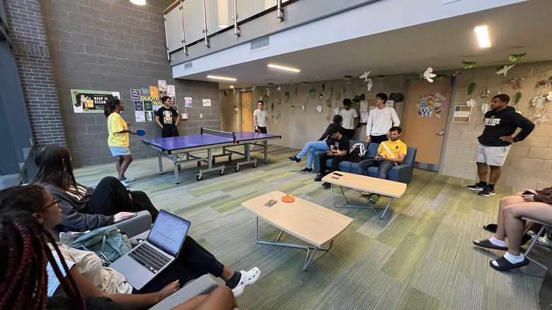 students playing ping pong in the lounge