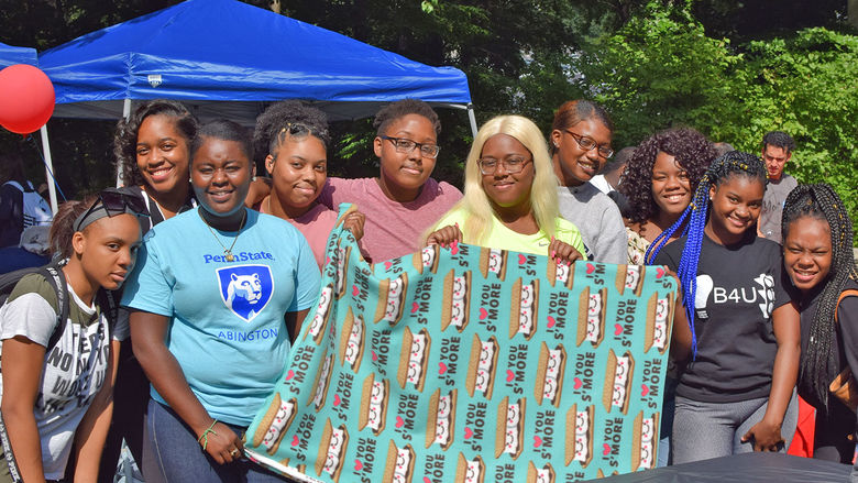 student group holding blanket