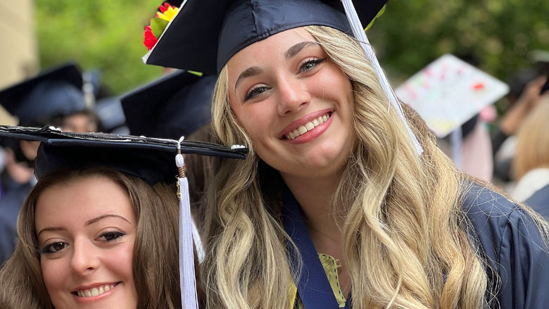 Two women after receiving their college diplomas