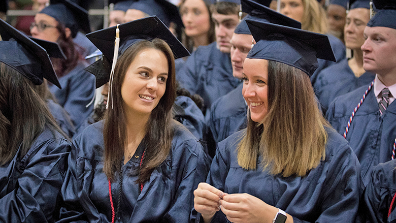 two graduates in audience
