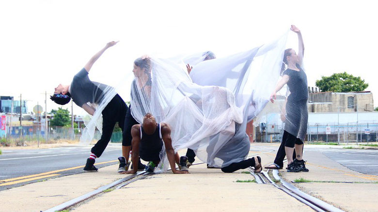 students dancing on train tracks