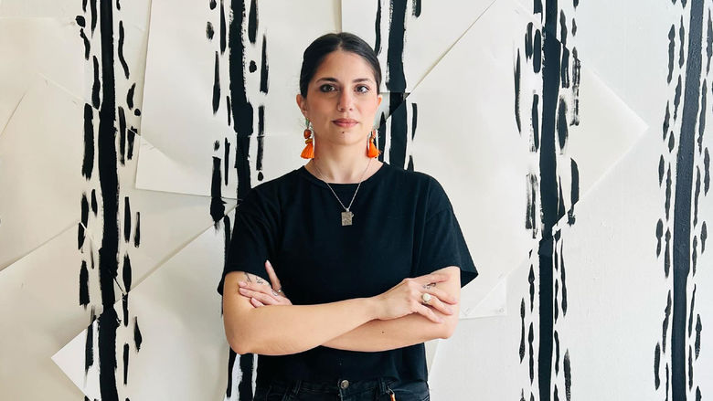 Person standing in front of white wall with black lines