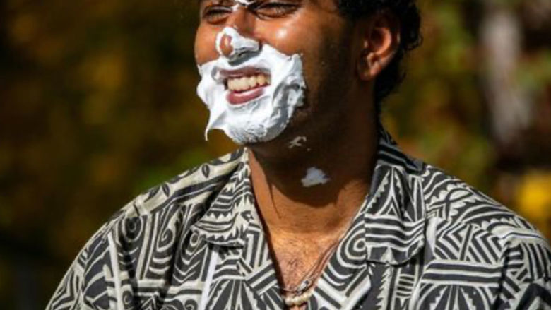 Man with shaving cream splattered on his face
