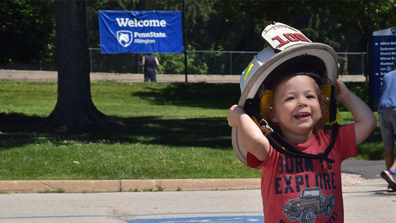 child wearing firefighter helment