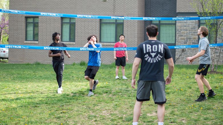 students playing volleyball outside of Lions Gate