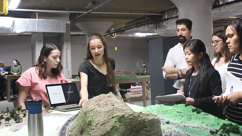 Magdalia Campobasso and Olivia Palmieri show their work to the judge’s panel during the final round of the WE Design Competition.