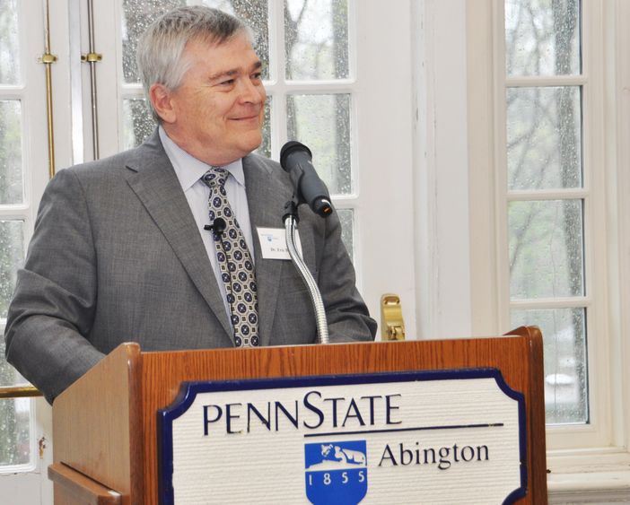 Penn State President Eric Barron standing at a podium