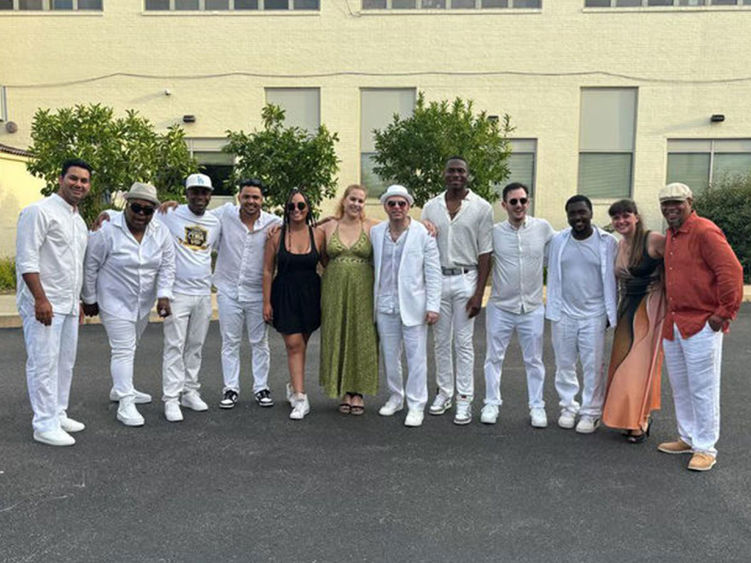 Large group of people standing arm in arm