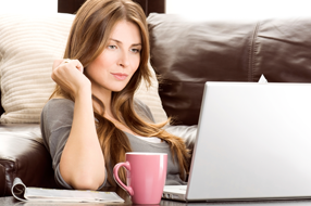woman on couch with laptop